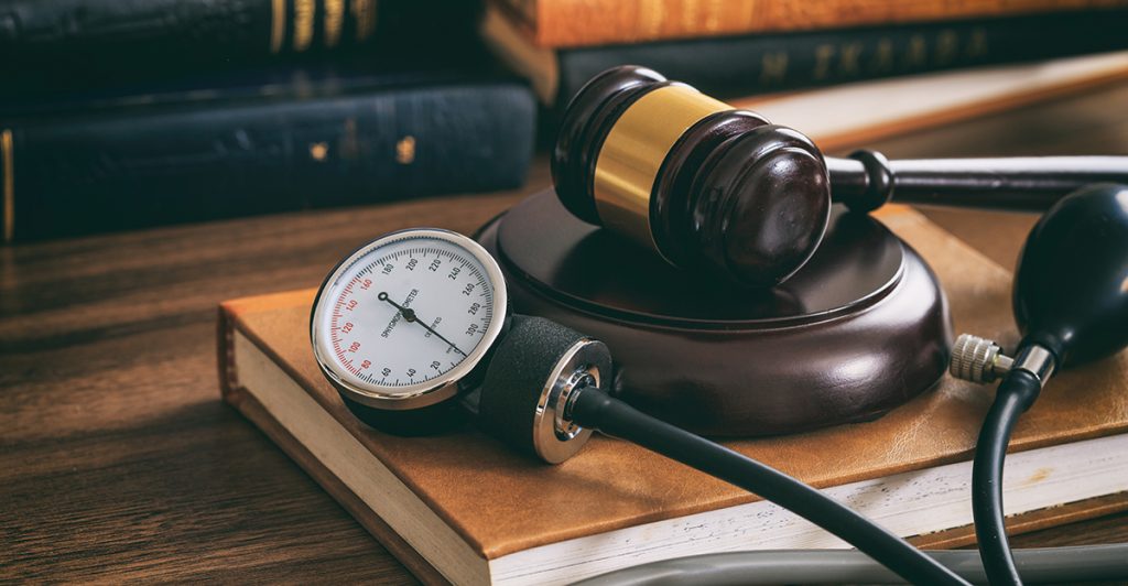 judge gavel and a blood pressure gauge on a PUJL